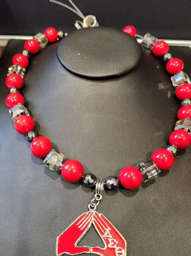 Style D02 – Red rounds, smoky crystal cubes, faceted black onyx/hematite, red enamel Delta hand-sign (ΔΣΘ) pendant