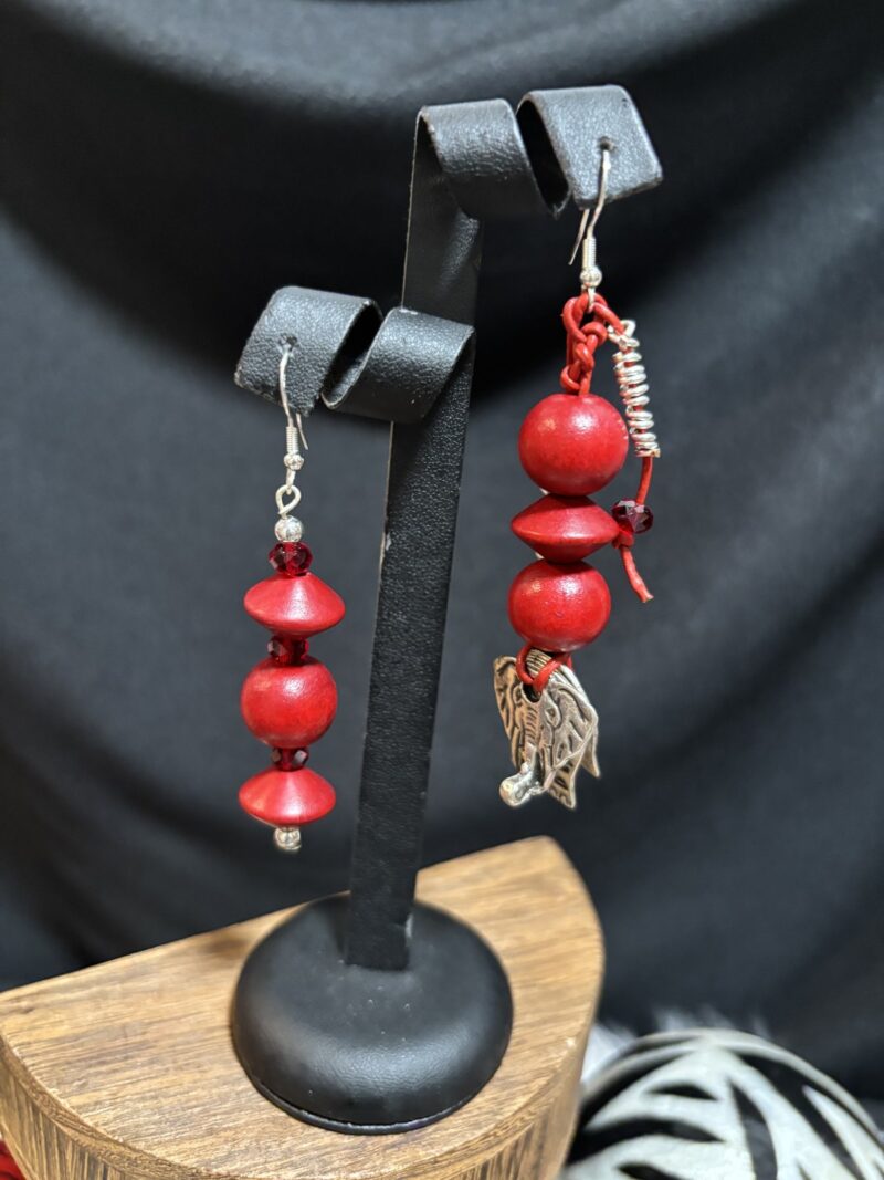 Style E09 – asymmetric: red saucer & round howlite beads / red rounds with red wire-wrapped silver elephant charm, silver hooks