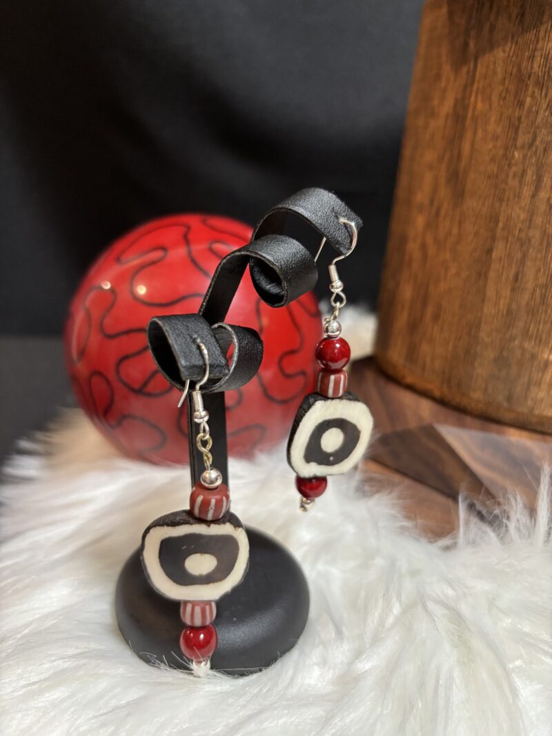 Style E10 – black & white bone eye donut, red chevron trade bead, red rounds, silver hooks
