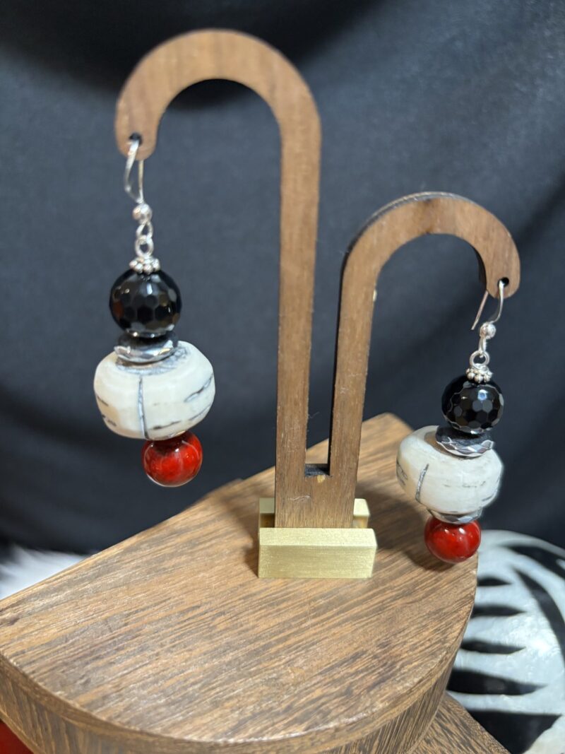 Style E11 – faceted black onyx, carved bone rondelle, red coral-tone round, silver spacers, silver hooks