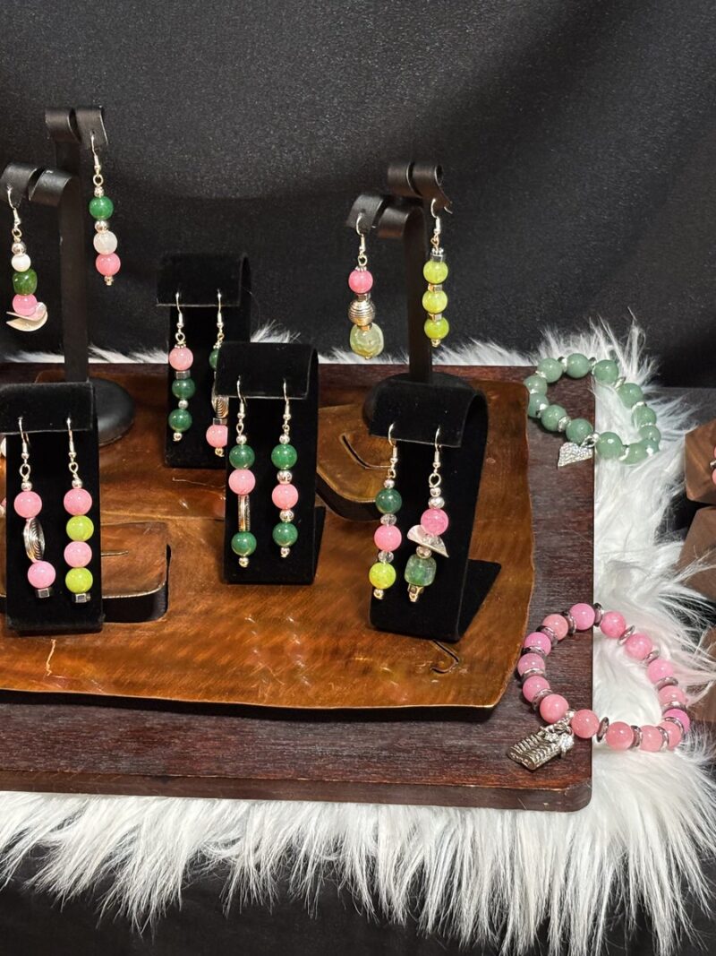 Style E21 – group shot: pink & green earring collection (pink, green, yellow-green agate/glass rounds) on black velvet stands