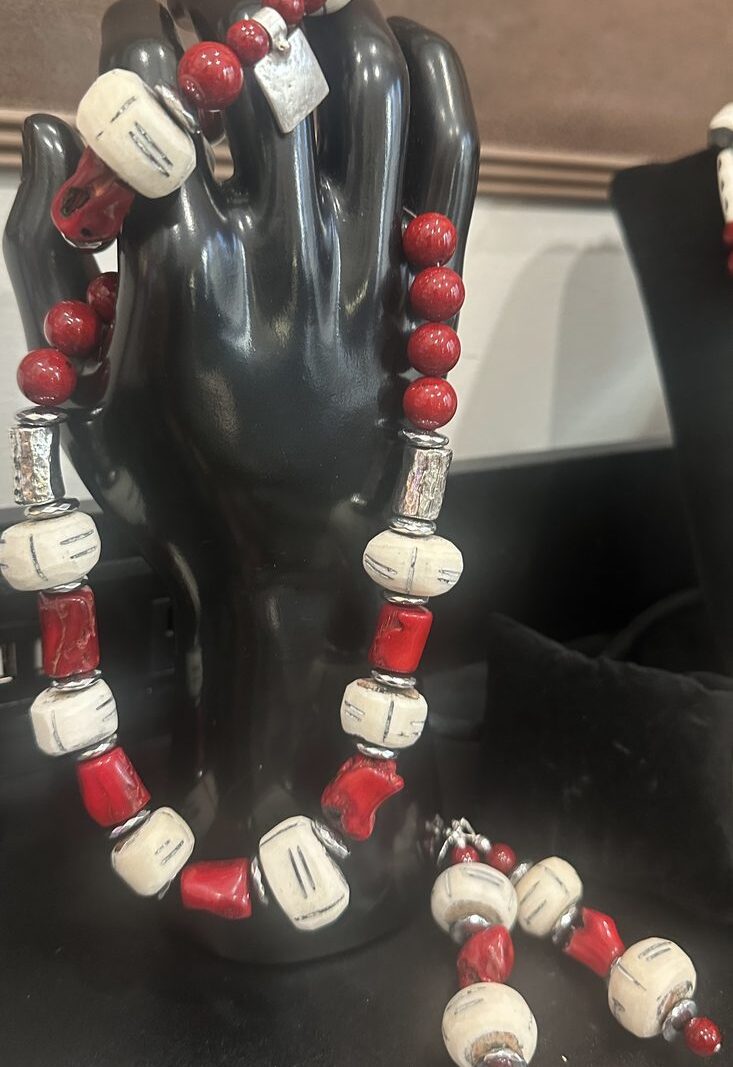 Style N10 – Red bamboo-coral tubes and red rounds alternating with incised cream bone rondelles, hammered silver tubes