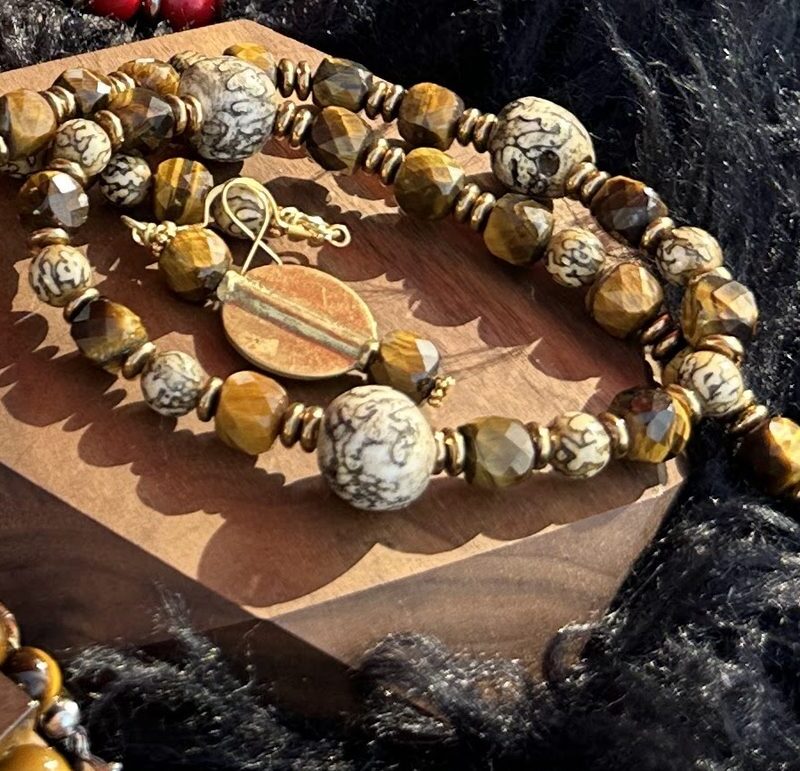 Style N16 – Faceted tiger eye and dendritic (snakeskin) jasper rounds with antique-gold heishi and chain extender